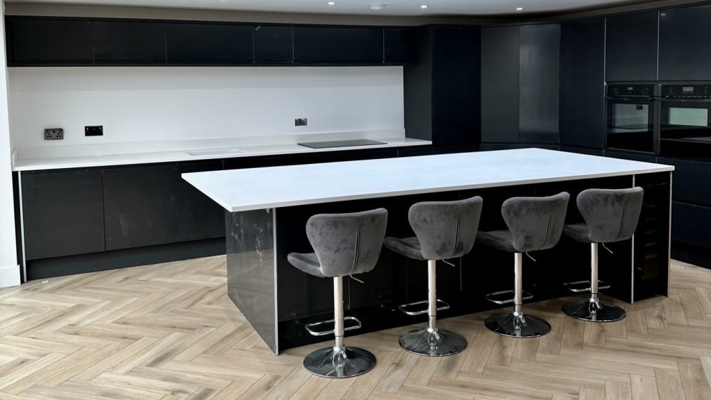 Modern Black and White Kitchen Design Elegance Modern black and white kitchen design with a stylish island and elegant herringbone flooring.